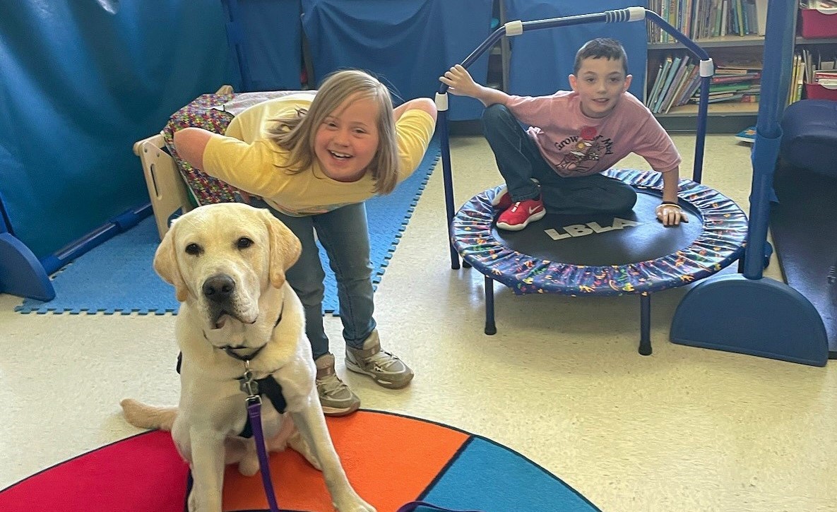 Evie Moore and Landon Hayes visiting with SSD Merino, service dog in training!