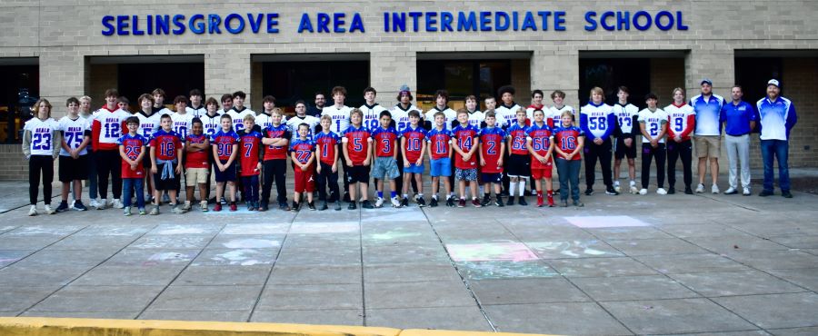 SAIS 4th Grade Football Players with the Varsity High School Football Players